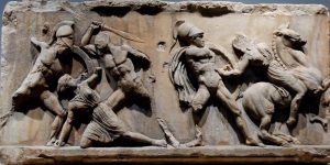Greek art of five men battling in ancient Greece.